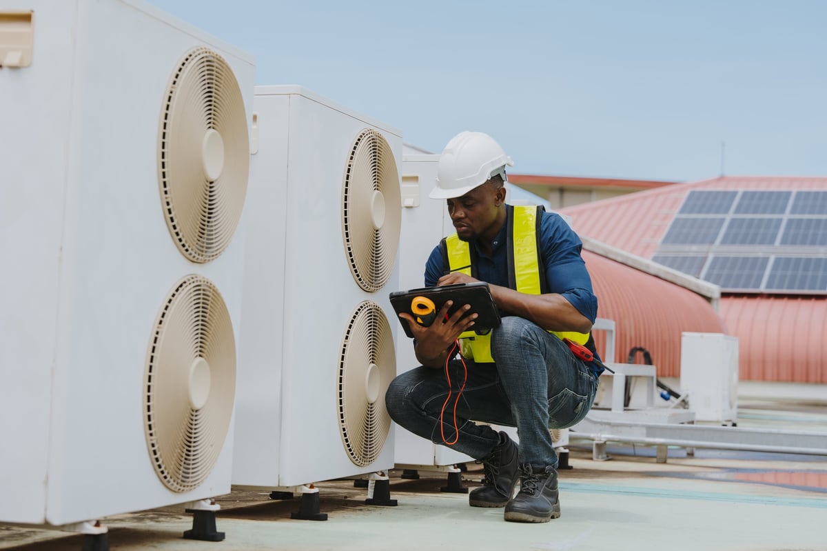 Engineers inspecting a commercial HVAC and cooling system
